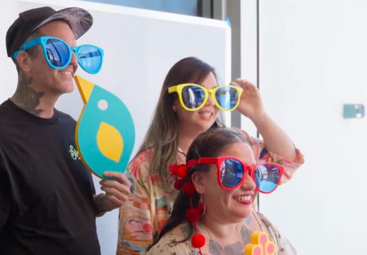 UXHI members at photobooth with sunglasses