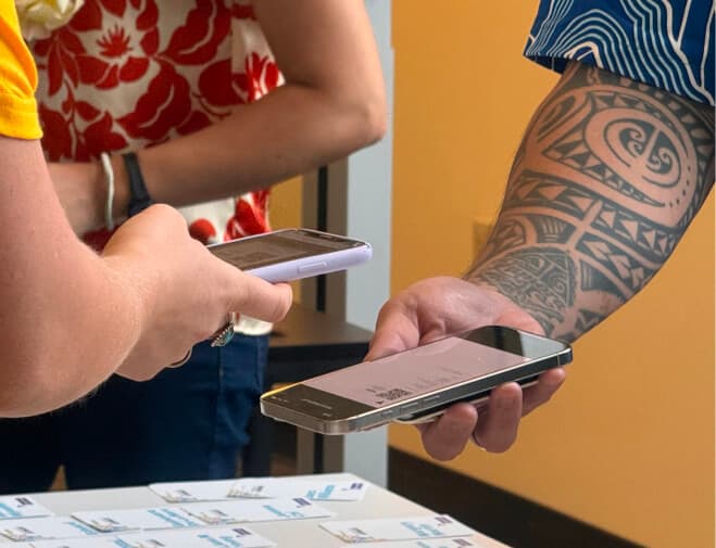 UXHI member sharing phone at event